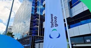 Tadweer – Abu Dhabi’s Center of Waste Management is a modern facility dedicated to advancing sustainable waste practices. The scene captures the center’s expansive grounds, clean infrastructure, and organized waste collection vehicles, reflecting efficiency and innovation. In the background, the Abu Dhabi skyline stands under a clear sky, symbolizing the city’s vision for a cleaner, greener future driven by circular economy principles.